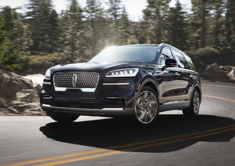 A Lincoln Aviator® SUV is being driven on a winding mountain road | Sheehy Lincoln of Richmond in Richmond VA