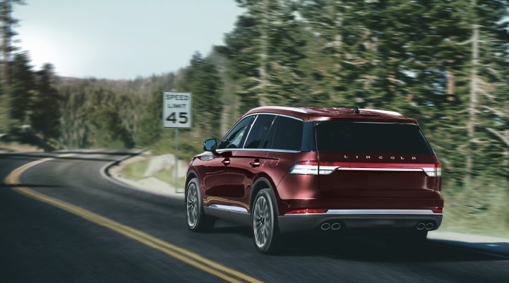 A 2024 Lincoln Aviator® SUV is being driven on a winding mountain road | Sheehy Lincoln of Richmond in Richmond VA