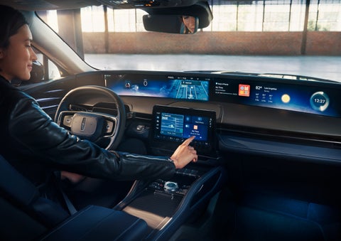 The driver of a 2024 Lincoln Nautilus® SUV interacts with the center touchscreen. | Sheehy Lincoln of Richmond in Richmond VA
